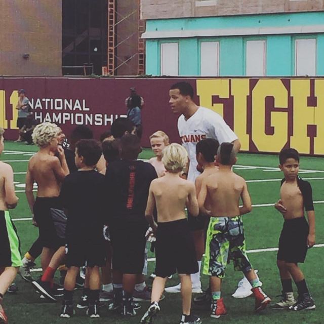 Youth Football Program — Adult Mentor + Kids w/ 'FIGHT' Banner